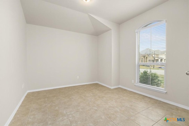 tiled empty room with a healthy amount of sunlight