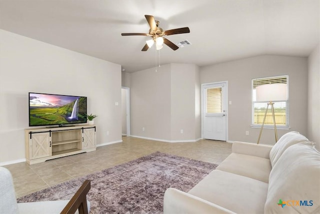 living room with light tile patterned floors, vaulted ceiling, and ceiling fan