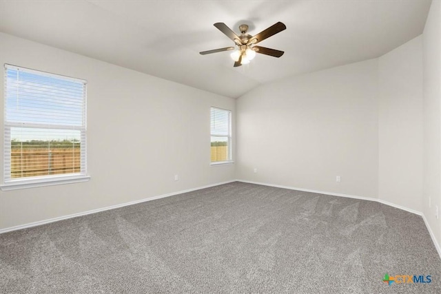 carpeted empty room featuring ceiling fan and lofted ceiling