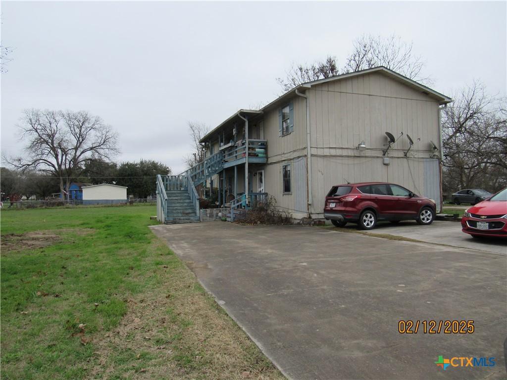 view of side of home with a lawn