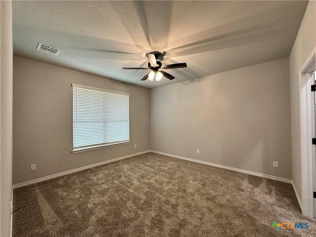 unfurnished room featuring ceiling fan, a textured ceiling, and dark colored carpet