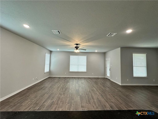 spare room featuring a wealth of natural light, ceiling fan, and a textured ceiling