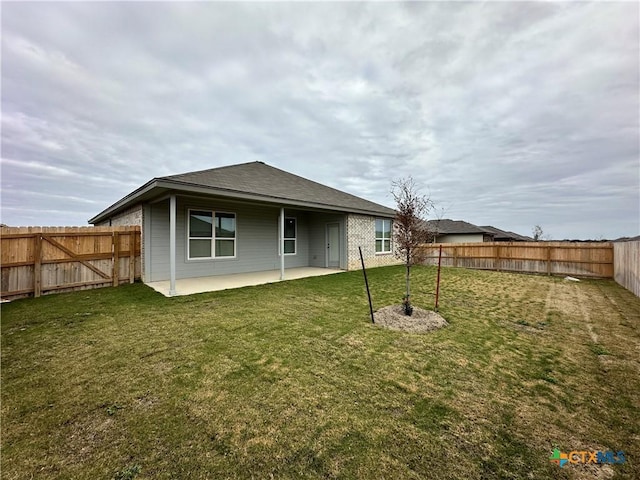 rear view of house with a patio area and a yard