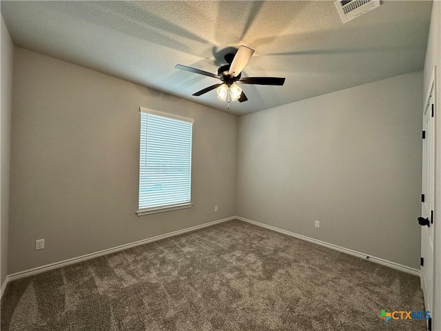 empty room featuring ceiling fan, carpet floors, and a textured ceiling