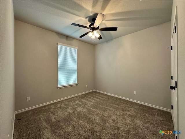 empty room featuring ceiling fan and dark colored carpet