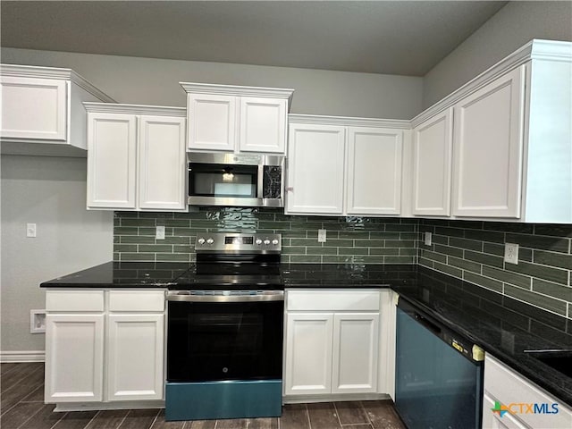 kitchen with backsplash, dark stone countertops, white cabinets, and appliances with stainless steel finishes