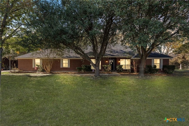 ranch-style home featuring a front yard