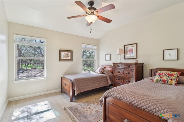 120 Oak Vis, New Braunfels, TX 78132 - bedroom featuring baseboards, light wood-style flooring, vaulted ceiling, and a ceiling fan