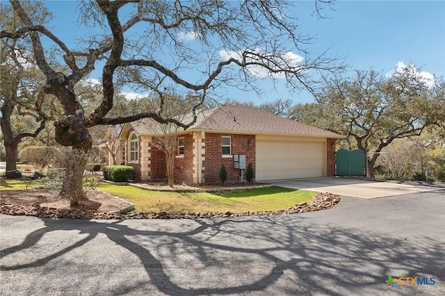 120 Oak Vis, New Braunfels, TX 78132 - view of front of home with brick siding, concrete driveway, a gate, and an attached garage