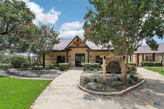 120 Oak Vis, New Braunfels, TX 78132 - modern inspired farmhouse with a standing seam roof, fence, metal roof, stone siding, and french doors