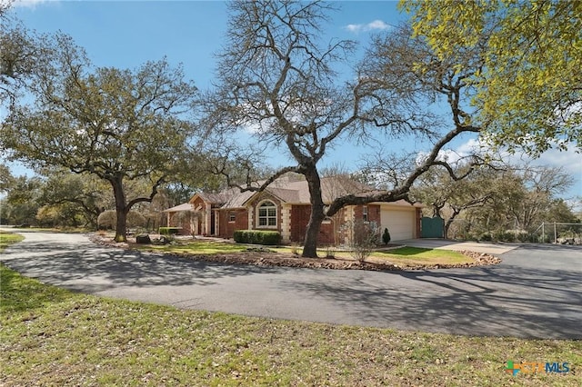 120 Oak Vis, New Braunfels, TX 78132 - view of front of property featuring driveway, an attached garage, and brick siding
