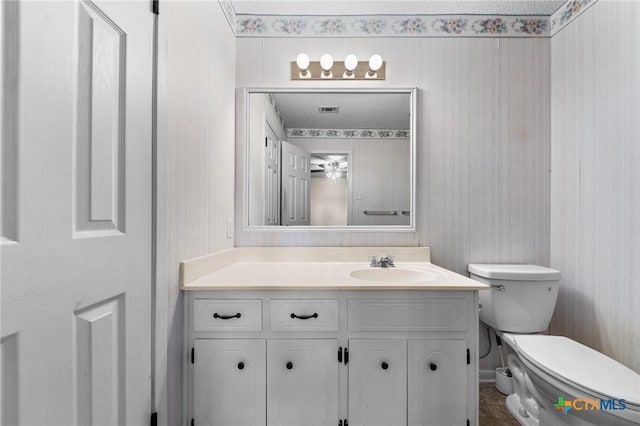 bathroom featuring toilet and vanity