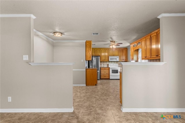 kitchen featuring white appliances, brown cabinets, ornamental molding, a ceiling fan, and baseboards