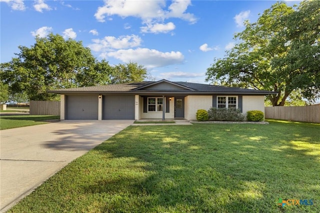 ranch-style home featuring an attached garage and driveway