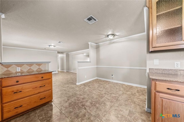 empty room featuring a textured ceiling, baseboards, and tile patterned flooring