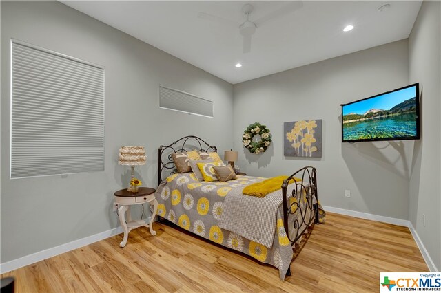 bedroom with wood-type flooring and ceiling fan