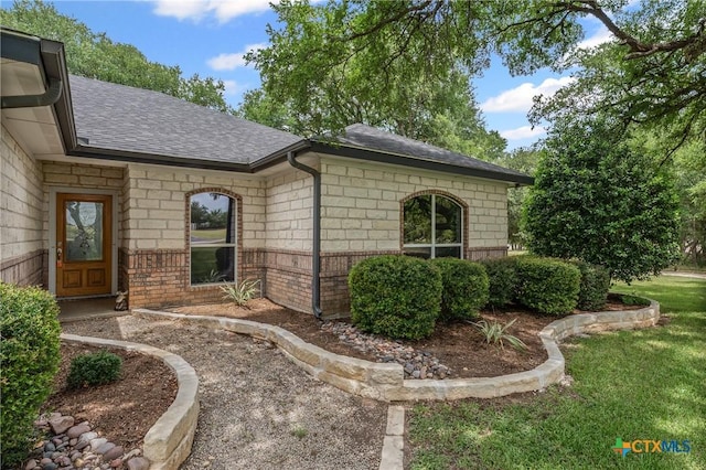 574 Rose Ln, Salado, TX 76571 - doorway to property featuring roof with shingles and brick siding