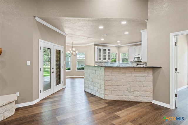 574 Rose Ln, Salado, TX 76571 - kitchen featuring stainless steel microwave, ornamental molding, white cabinets, a chandelier, and dark wood finished floors