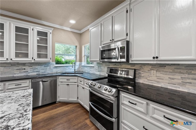 574 Rose Ln, Salado, TX 76571 - kitchen with appliances with stainless steel finishes, crown molding, tasteful backsplash, white cabinetry, and recessed lighting