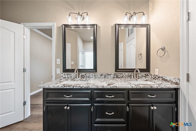 574 Rose Ln, Salado, TX 76571 - bathroom featuring double vanity and wood finished floors