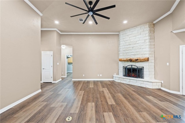 574 Rose Ln, Salado, TX 76571 - unfurnished living room featuring ceiling fan, a fireplace, crown molding, wood finished floors, and recessed lighting