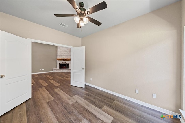 574 Rose Ln, Salado, TX 76571 - spare room with a ceiling fan, a fireplace with raised hearth, and wood finished floors