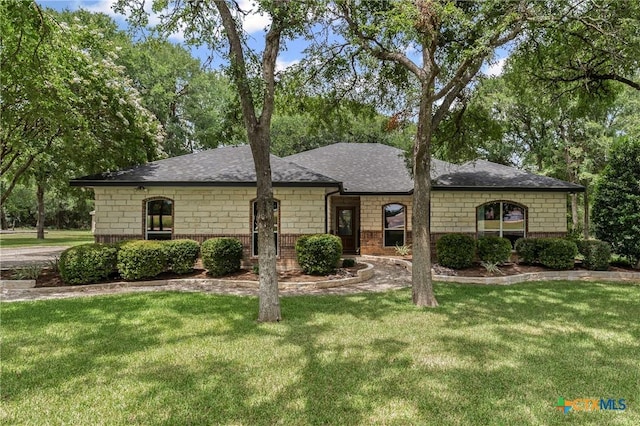 574 Rose Ln, Salado, TX 76571 - view of front of home featuring a front lawn, a shingled roof, and brick siding