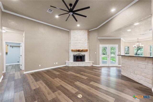 574 Rose Ln, Salado, TX 76571 - unfurnished living room with a chandelier, a stone fireplace, dark wood-style floors, ornamental molding, and ceiling fan