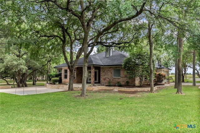 574 Rose Ln, Salado, TX 76571 - view of front of house featuring a front yard, brick siding, and a shingled roof
