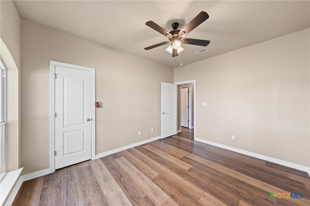 574 Rose Ln, Salado, TX 76571 - unfurnished bedroom with wood finished floors and a ceiling fan