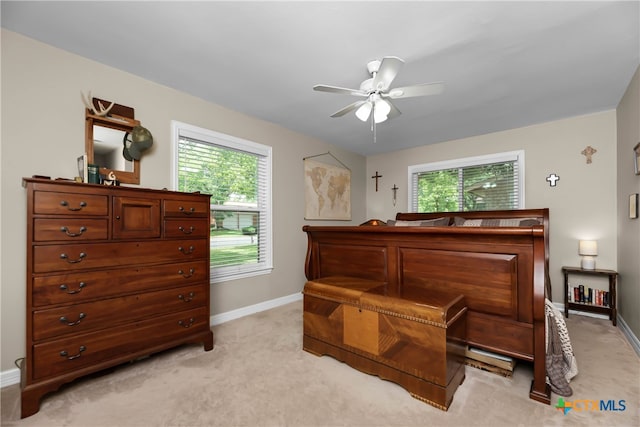 carpeted bedroom featuring multiple windows and ceiling fan