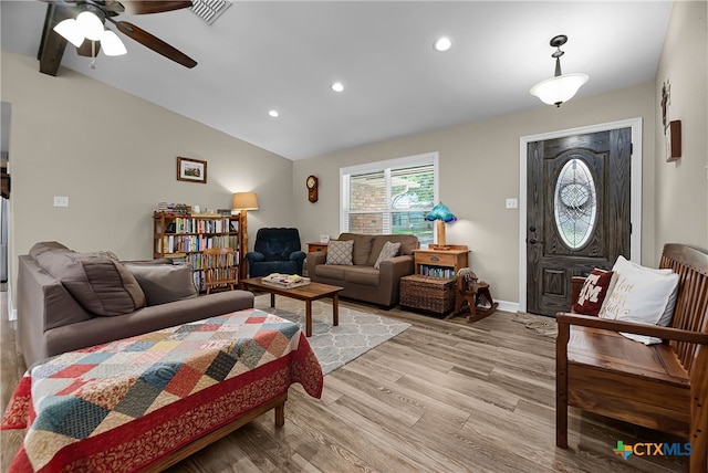 living room with light hardwood / wood-style flooring, vaulted ceiling with beams, and ceiling fan