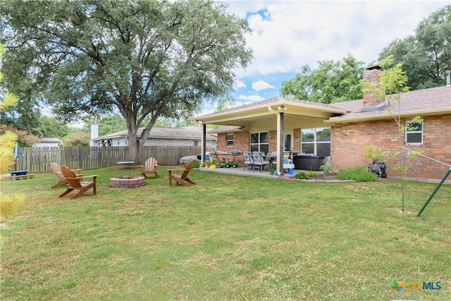 view of yard featuring a patio and an outdoor fire pit