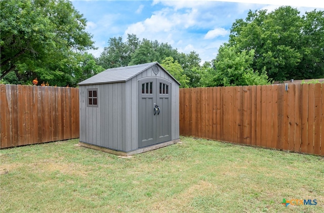 view of outbuilding featuring a lawn