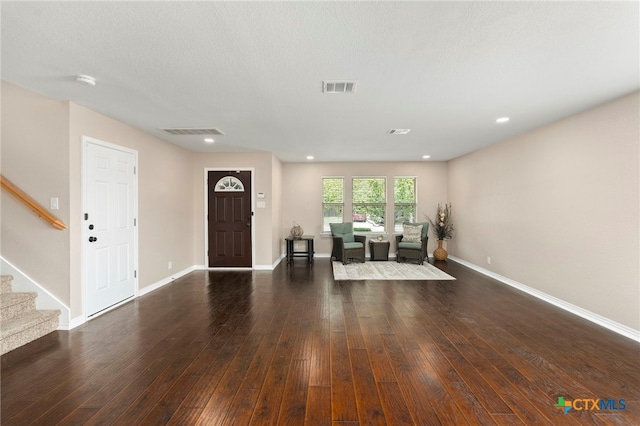 foyer featuring dark hardwood / wood-style floors and a textured ceiling