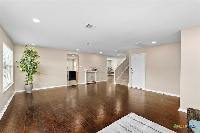 unfurnished living room featuring dark wood-type flooring