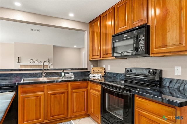 kitchen with light tile patterned floors, sink, and black appliances