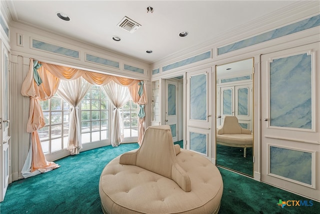 sitting room featuring carpet flooring and ornamental molding