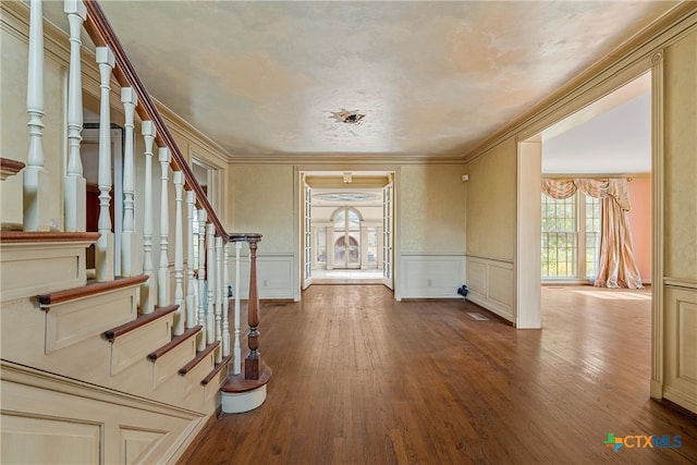 entrance foyer with hardwood / wood-style floors and crown molding