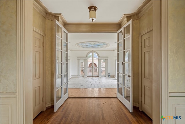 corridor with french doors and hardwood / wood-style floors