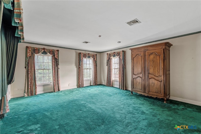 unfurnished bedroom with dark carpet and ornamental molding