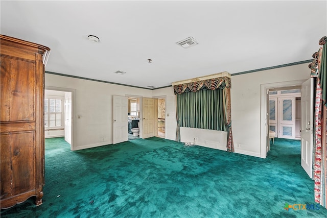 spare room featuring dark carpet and ornamental molding