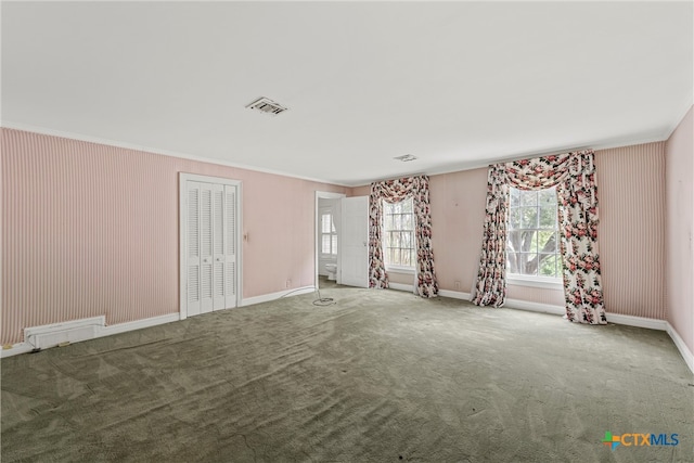 unfurnished room featuring carpet flooring and crown molding