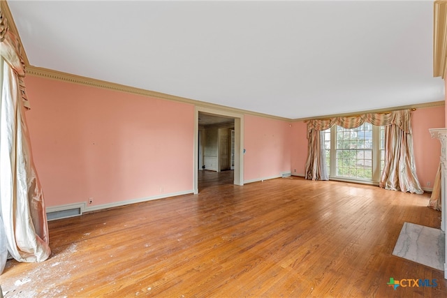 interior space with ornamental molding and light wood-type flooring