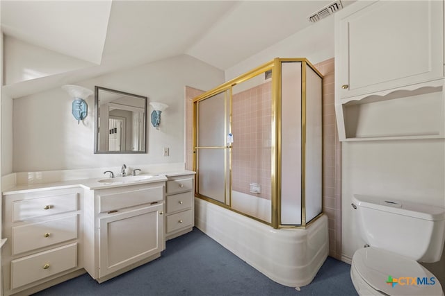 full bathroom with vanity, combined bath / shower with glass door, toilet, and vaulted ceiling