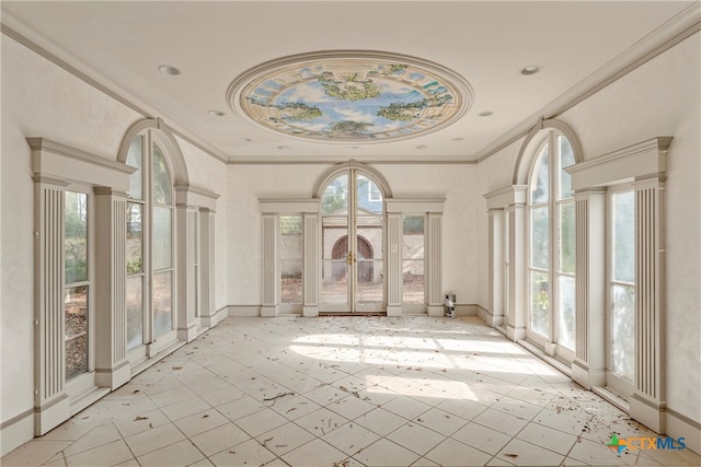 misc room featuring a healthy amount of sunlight, crown molding, and decorative columns