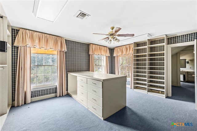 spacious closet with light colored carpet and ceiling fan