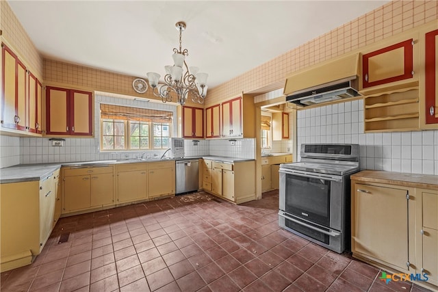 kitchen featuring stainless steel appliances, backsplash, extractor fan, hanging light fixtures, and a chandelier