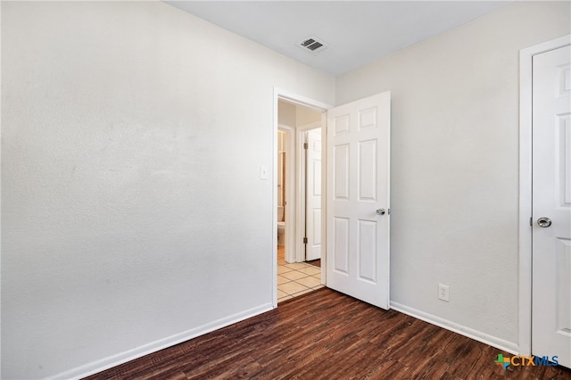 unfurnished bedroom featuring dark wood-type flooring