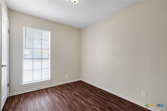 spare room featuring dark hardwood / wood-style flooring